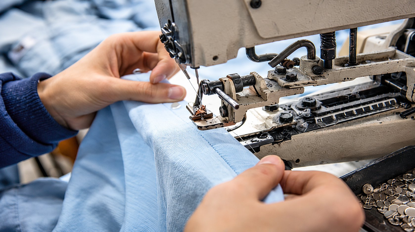 Close-up of a machine needle stitching patterned fabric